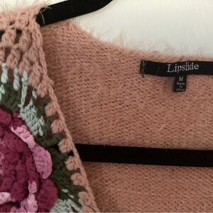 Fluffy peach sweater with crochet flower